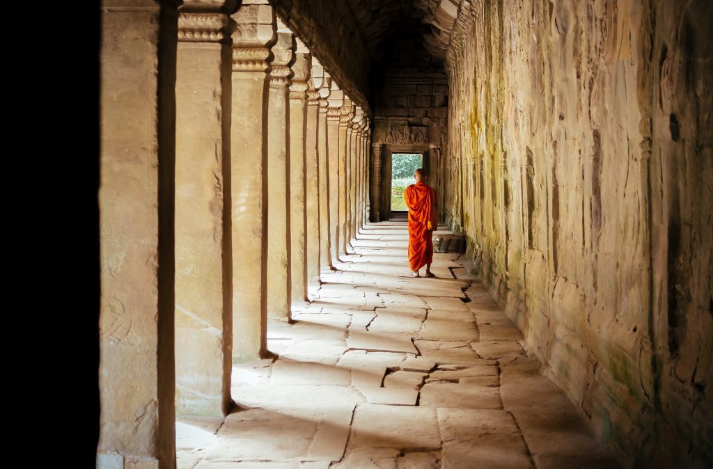 Wellness Journey - A monk walks through quiet corridors