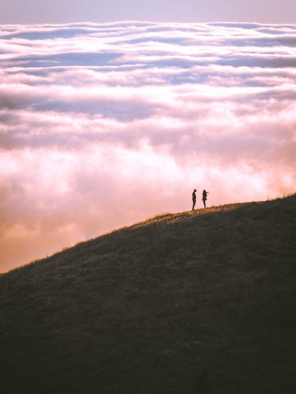 Honeymoon Planning - couple against a backdrop of clouds