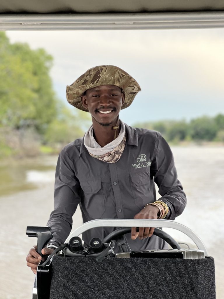The infectious smile of one of our guides in Zimbabwe cruising down the Zambezi River