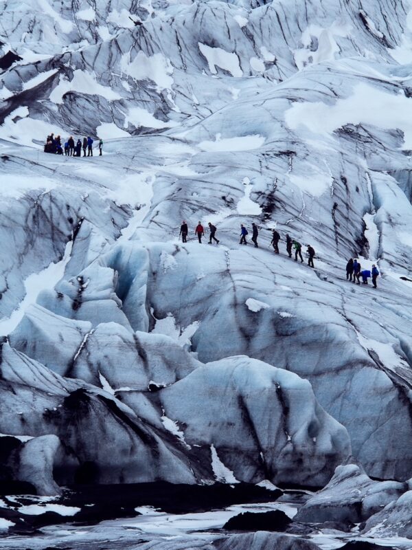 Corporate Travel - group scale huge rocks